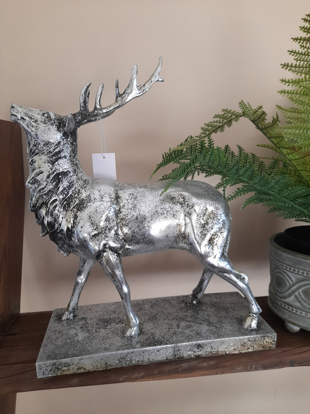 large silver stag on plinth